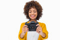 Attractive girl holding a camera on white background Stock Photos
