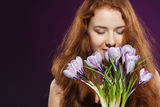 Beautiful redheaded female smelling the crocuses Royalty Free Stock Photos