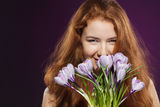 Beautiful redheaded female smelling the crocuses Royalty Free Stock Image