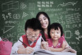 Beautiful teacher see children writing in class close up of and classroom Stock Photography