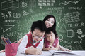 Boy and his sister study in class with teacher asian brother is learning to write the Royalty Free Stock Image