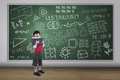 Boy reading book with written chalkboard asian full length shot Stock Photos