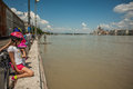 Budapest floods people watching the show of the swollen danube on its banks in Stock Image