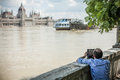 Budapest floods people watching the show of the swollen danube on its banks in Royalty Free Stock Images
