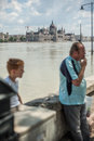 Budapest floods people watching the show of the swollen danube on its banks in Royalty Free Stock Image