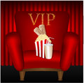 Chair and popcorn and a drink on background of red curtains Royalty Free Stock Photos