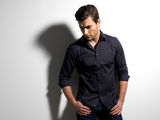 Fashion portrait of young man in black shirt Stock Photography