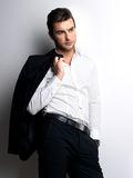 Fashion young man in white shirt holds the black jacket Stock Photo