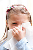Girl blowing nose Royalty Free Stock Photos