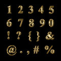 Gold numbers punctuation and symbols on a black background Stock Image
