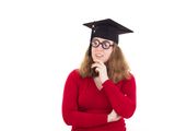 Graduate thinking about her studies Royalty Free Stock Images
