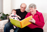 Grandparents reading book to baby girl Royalty Free Stock Photography