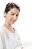 Isolated beautiful eyeglasses on head young girl reading book on white background Stock Photo
