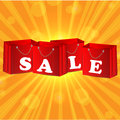 Paper shopping bags in red on orange background Royalty Free Stock Images