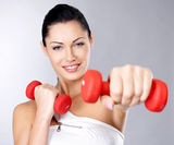 Photo of a healthy training young woman with dumbbells Stock Photo