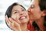 Portrait Of Adult Daughter Kissing Mother Royalty Free Stock Photos
