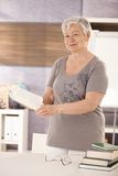 Senior teacher holding textbook Stock Image