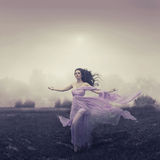 Portrait of woman running over the field Royalty Free Stock Photo