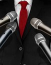 Press interview with microphones and a man a black suit Royalty Free Stock Photography