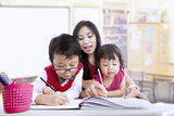 Teacher and children study in classroom Royalty Free Stock Photography