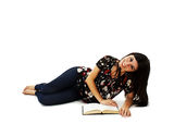 Young attractive girl lying and reading book Stock Images