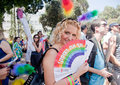 Young girl supporting pride parade tel aviv june beautiful female supporter of poses at the camera with rainbow fan with gay Stock Photos